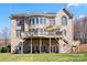 Back of brick home featuring second-story deck with outdoor furniture, patio, stairs, and yard at 9433 Wallace Pond Dr, Huntersville, NC 28078