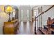 Inviting foyer featuring hardwood floors, arched doorways, staircase, and a stylish console table at 9433 Wallace Pond Dr, Huntersville, NC 28078