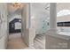 Hallway view leading to a luxury bathroom with a glass shower, tub, and modern vanity at 9433 Wallace Pond Dr, Huntersville, NC 28078