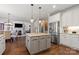 Spacious kitchen featuring an island with seating, granite countertops, and stainless steel appliances at 9433 Wallace Pond Dr, Huntersville, NC 28078