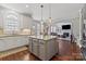 Gourmet kitchen featuring an island, granite countertops, stainless steel appliances, and hardwood floors at 9433 Wallace Pond Dr, Huntersville, NC 28078