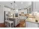 Modern kitchen with white cabinetry, an island with seating, stainless steel appliances, and granite countertops at 9433 Wallace Pond Dr, Huntersville, NC 28078