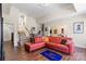 Cozy living room with hardwood floors and a red L-shaped couch perfect for relaxing at 9433 Wallace Pond Dr, Huntersville, NC 28078