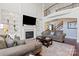 Spacious living room with a soaring ceiling, fireplace, built-in shelves, and large windows that provide an abundance of natural light at 9433 Wallace Pond Dr, Huntersville, NC 28078