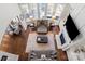 From above, a spacious living room with high ceilings, a fireplace, built-in shelving, hardwood floors, and lots of seating at 9433 Wallace Pond Dr, Huntersville, NC 28078