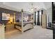 Comfortable main bedroom with a four-poster bed, ceiling fan, and arched windows offering natural light at 9433 Wallace Pond Dr, Huntersville, NC 28078