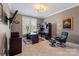 Comfortable home office includes a desk, comfortable chairs, and a window with a view of the backyard at 9433 Wallace Pond Dr, Huntersville, NC 28078