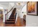 Elegant staircase features dark wood steps and iron railings. Arched doorways lead to the living room and dining room areas at 9433 Wallace Pond Dr, Huntersville, NC 28078