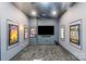 Entertainment room with gray walls, plush carpet and movie posters for a night of relaxation at 9433 Wallace Pond Dr, Huntersville, NC 28078