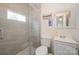 Tiled bathroom featuring a tiled shower with glass door, vanity, and modern fixtures at 9937 Harwood Ln, Charlotte, NC 28214