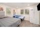 Shared bedroom with two twin beds, built-in wardrobe, and windows providing natural light at 9937 Harwood Ln, Charlotte, NC 28214