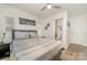 Relaxing bedroom featuring a cozy bed, ceiling fan, and an en-suite bathroom for added convenience at 9937 Harwood Ln, Charlotte, NC 28214