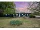 Charming home featuring a well-maintained lawn with mature trees and a cozy, inviting entrance at 9937 Harwood Ln, Charlotte, NC 28214