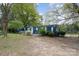 Charming home featuring a well-maintained lawn, mature trees, and inviting curb appeal at 9937 Harwood Ln, Charlotte, NC 28214
