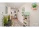 Bright hallway with decor, laminate flooring, and ample natural light streaming through a window at 9937 Harwood Ln, Charlotte, NC 28214