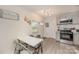 Charming kitchen with stainless steel appliances and a cozy dining area with a white table and chairs at 9937 Harwood Ln, Charlotte, NC 28214