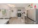 Modern kitchen featuring stainless steel appliances, light gray cabinetry, and stylish backsplash at 9937 Harwood Ln, Charlotte, NC 28214