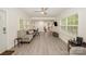 Bright living room featuring laminate flooring, large windows, and inviting seating arrangements at 9937 Harwood Ln, Charlotte, NC 28214