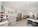 Open-concept kitchen and living room with stainless steel appliances, light gray cabinetry, and wood-look flooring at 9937 Harwood Ln, Charlotte, NC 28214