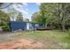 Exterior of house with a large grassy yard, multiple entry points, and a welcoming deck at 9937 Harwood Ln, Charlotte, NC 28214