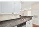 Kitchen area featuring a stainless steel sink, granite countertops, and updated appliances at 10125 Westmoreland Rd, Cornelius, NC 28031