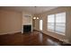 The sunlit living room features hardwood floors and a fireplace at 10125 Westmoreland Rd, Cornelius, NC 28031