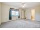 Bedroom features neutral walls, plush carpeting, window, and access to an ensuite bathroom at 1022 Kannapolis Pkwy, Concord, NC 28027