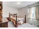 Bedroom with carpet flooring, side table, and dark-stained wood bed near the window at 1022 Kannapolis Pkwy, Concord, NC 28027