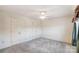 Bright bedroom features neutral walls, carpet flooring, and a ceiling fan with integrated lighting at 1022 Kannapolis Pkwy, Concord, NC 28027