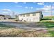 A white two-story home with attached garage, showcasing a curved driveway and lawn at 1022 Kannapolis Pkwy, Concord, NC 28027
