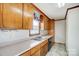Efficient kitchen design with wood cabinets, laminate countertops, and essential appliances at 1022 Kannapolis Pkwy, Concord, NC 28027
