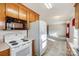 Kitchen with stove, microwave, refrigerator, wood cabinets and access to living room at 1022 Kannapolis Pkwy, Concord, NC 28027