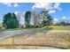 A serene view of a home nestled among mature trees, accessible via a paved driveway at 1022 Kannapolis Pkwy, Concord, NC 28027