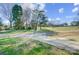 Scenic property view with a circular driveway leading to a home surrounded by mature trees at 1022 Kannapolis Pkwy, Concord, NC 28027