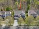 Aerial view of a well-maintained home with a spacious driveway and mature trees in a peaceful neighborhood at 1033 Ridge Haven Rd, Waxhaw, NC 28173
