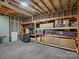 Unfinished basement with shelving units, providing ample storage space and potential for customization at 1033 Ridge Haven Rd, Waxhaw, NC 28173