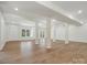 Spacious finished basement featuring an open layout, laminate flooring, white support beams, and natural light at 1033 Ridge Haven Rd, Waxhaw, NC 28173