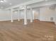 Open finished basement with laminate flooring, recessed lighting, and support beams, offering versatile space at 1033 Ridge Haven Rd, Waxhaw, NC 28173