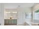 Bright bathroom with double vanity, soaking tub, and tiled floors at 1033 Ridge Haven Rd, Waxhaw, NC 28173