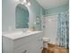 Stylish bathroom features a modern vanity, framed mirror, and shower/tub combo with a patterned curtain at 1033 Ridge Haven Rd, Waxhaw, NC 28173