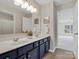 Bathroom featuring double sinks, large mirror and tile floor at 1033 Ridge Haven Rd, Waxhaw, NC 28173