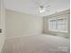 Neutral bedroom with carpet, ceiling fan, and window offering natural light at 1033 Ridge Haven Rd, Waxhaw, NC 28173