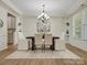 Elegant dining room with tray ceilings, modern chandelier, and stylish furnishings at 1033 Ridge Haven Rd, Waxhaw, NC 28173