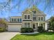 Charming two-story home with a manicured front lawn, attached garage, and neutral toned siding at 1033 Ridge Haven Rd, Waxhaw, NC 28173