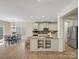 Spacious kitchen featuring stainless steel appliances, granite countertops, and an adjacent dining area at 1033 Ridge Haven Rd, Waxhaw, NC 28173