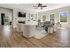 Bright and airy living room with a fireplace, ceiling fan, and large windows offering natural light at 1033 Ridge Haven Rd, Waxhaw, NC 28173