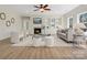 Bright living room with fireplace, built-in shelving, ceiling fan, and ample seating at 1033 Ridge Haven Rd, Waxhaw, NC 28173