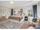 Beautiful main bedroom featuring hardwood floors, tray ceiling, and abundant natural light at 1033 Ridge Haven Rd, Waxhaw, NC 28173