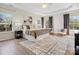 Spacious main bedroom with tray ceiling, large windows, and hardwood floors at 1033 Ridge Haven Rd, Waxhaw, NC 28173