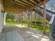 Covered patio with stone flooring and wooden supports that provide shaded outdoor relaxation and entertainment space at 1033 Ridge Haven Rd, Waxhaw, NC 28173